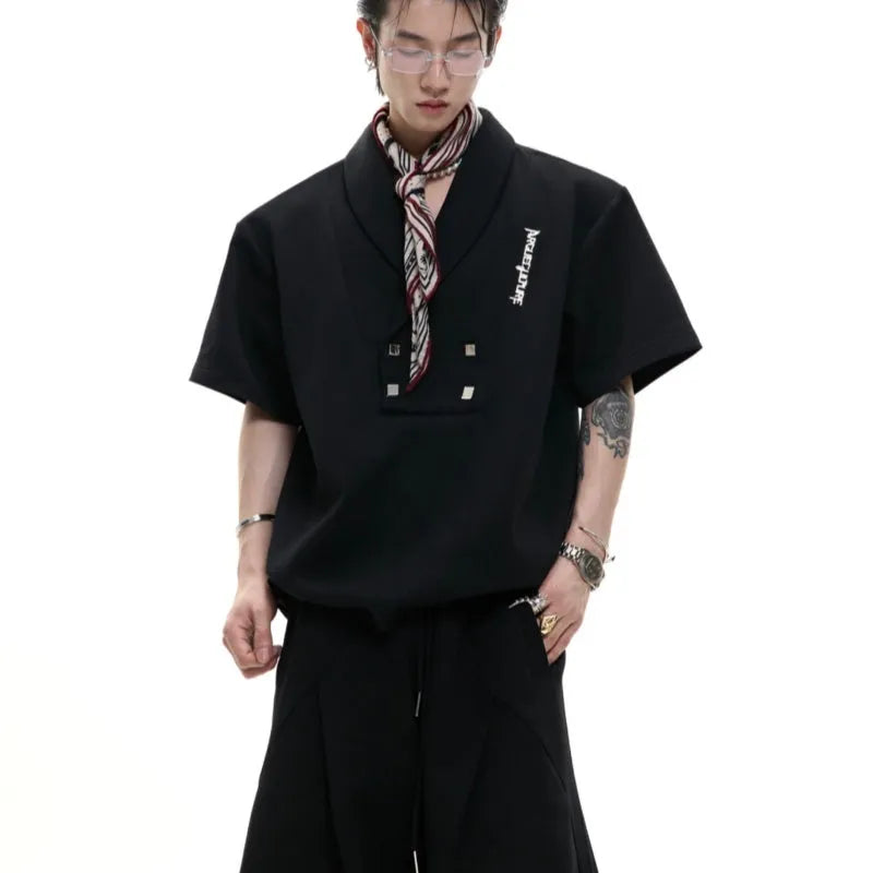 Men's dark grey cotton sports suit with padded shoulders, metal embellishments, V-neck, and matching shorts