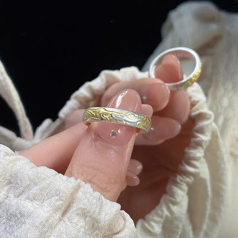 Open-mouth geometric ring with engraved xiangyun pattern in electroplated white copper showing silver and gold finish options