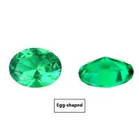 A loose cultivated emerald gemstone in Columbia green treasure colour on a white background.