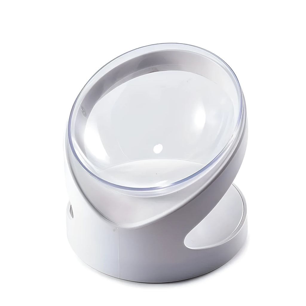 White clear plastic tilted cat food bowl on a flat surface.