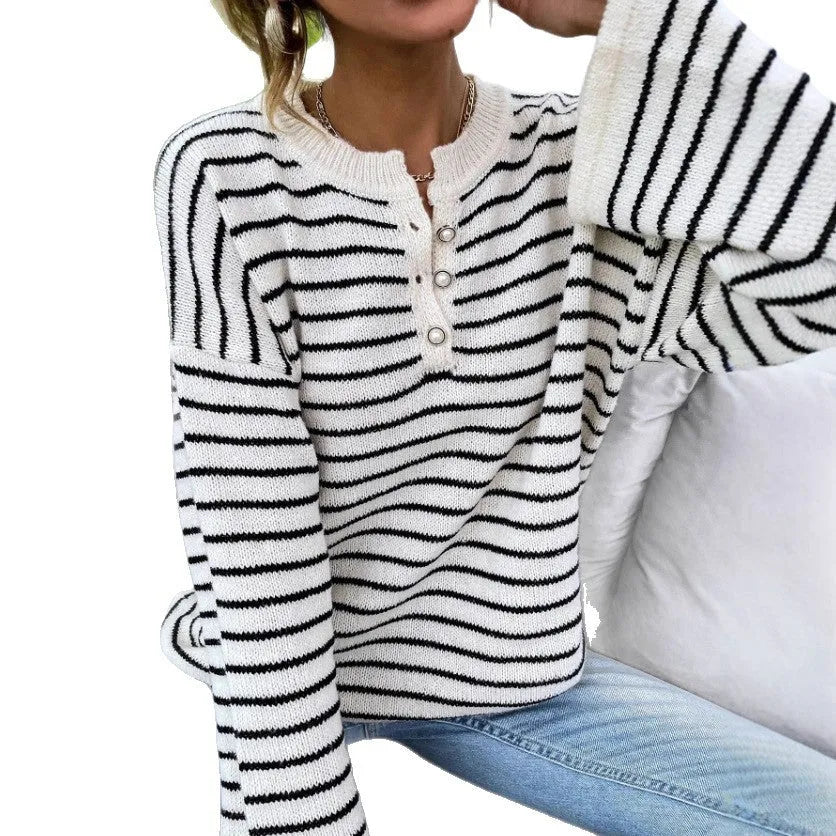 Black striped women's casual top with drop-shoulder sleeves on hanger