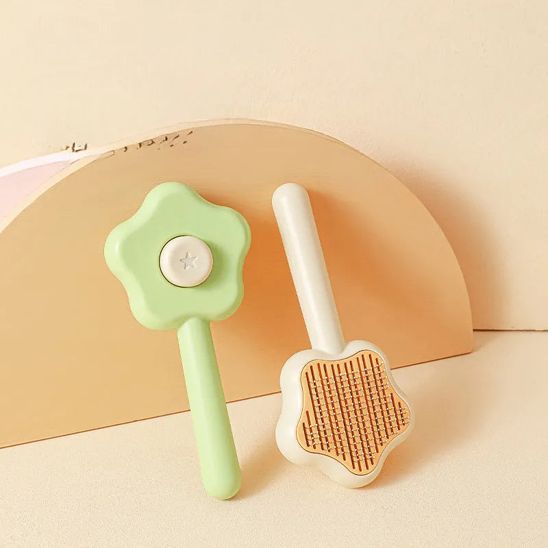 Green or yellow self-cleaning cat comb with stainless steel teeth, showing 20cm length.