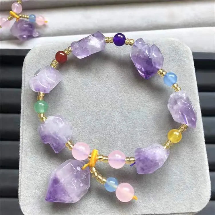 Natural shaped purple amethyst bead bracelet for women with a fu character charm.