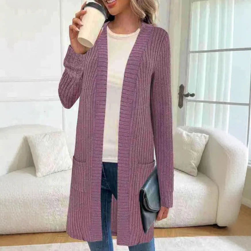 A woman's long sleeve loose-fit knitted cardigan jacket with pockets in wine red.