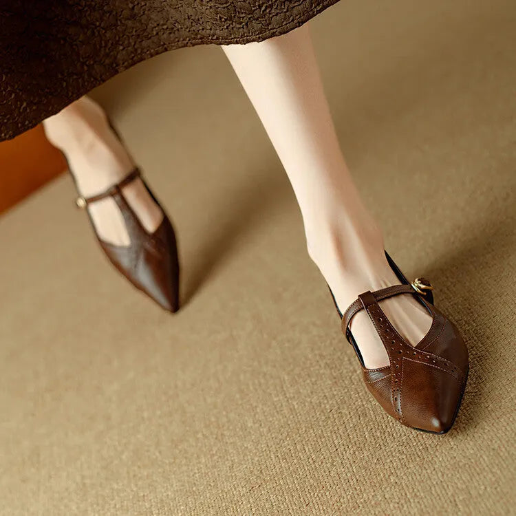 Brown women's pointed toe low-cut flat shoes with a mid heel on a neutral background.