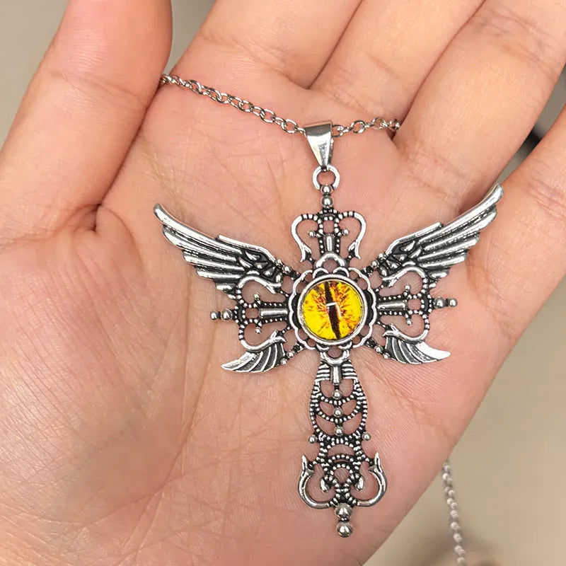 Close-up of a devil wings and cross geometric alloy pendant necklace on a chain.