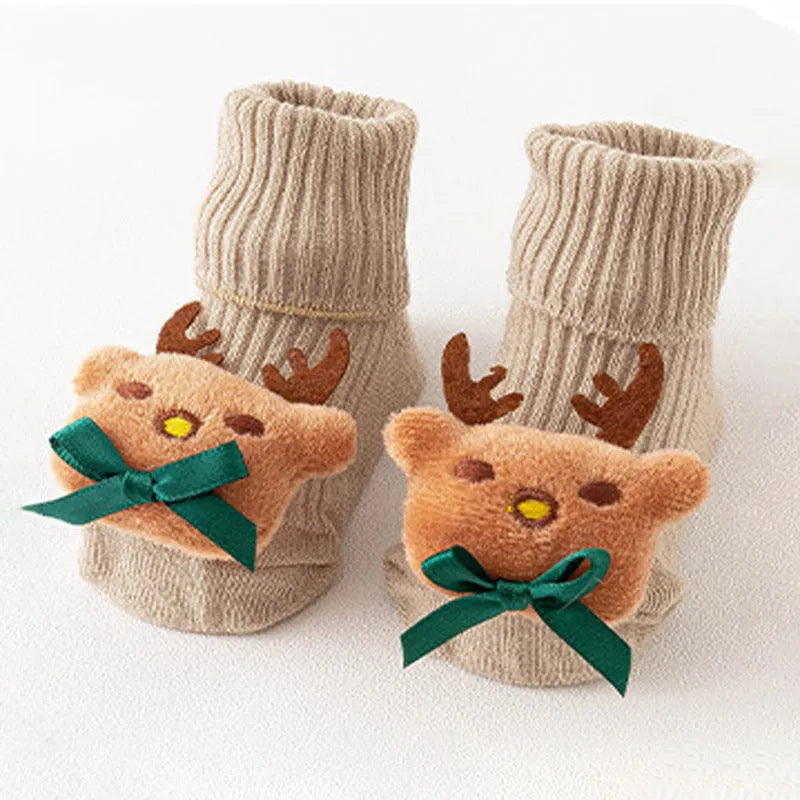 Cotton baby floor socks in various designs including blue bow and lion, showing sizes for infants 0-3 months