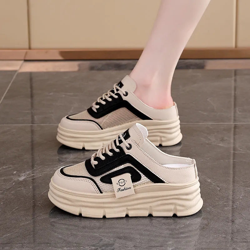 Women's black mesh half slippers with round toe and rubber sole on a white background.