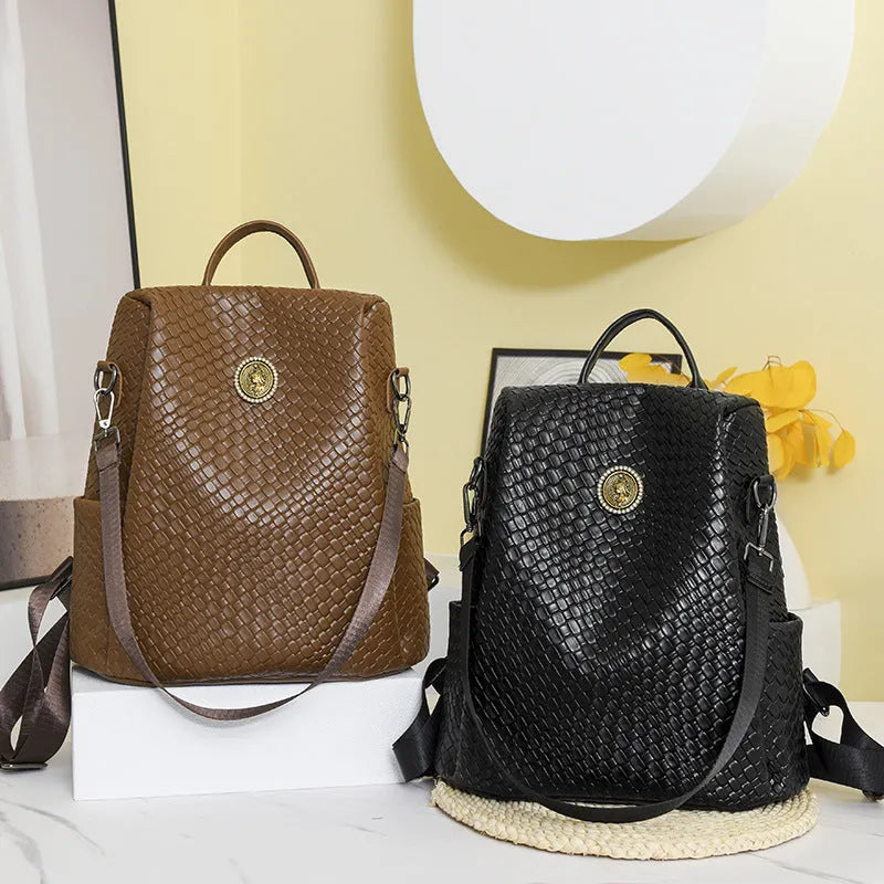 Women's black anti-theft backpack with waterproof PU construction showing organisational pockets and stitching details