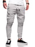 Men's loose fit polyester trousers with patch pockets and elastic waistband in light blue colour
