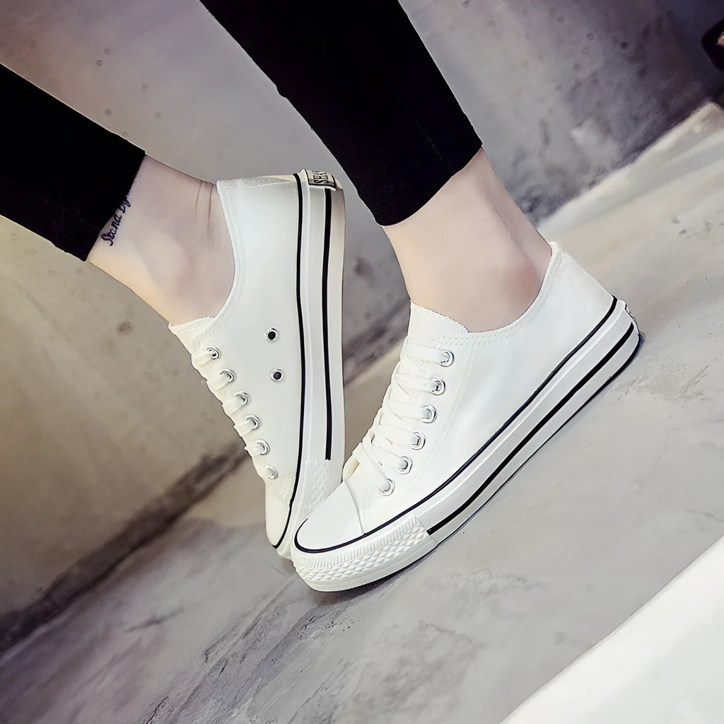 Women's solid colour canvas casual shoes shown in black, white black, white red, and all black colour options.