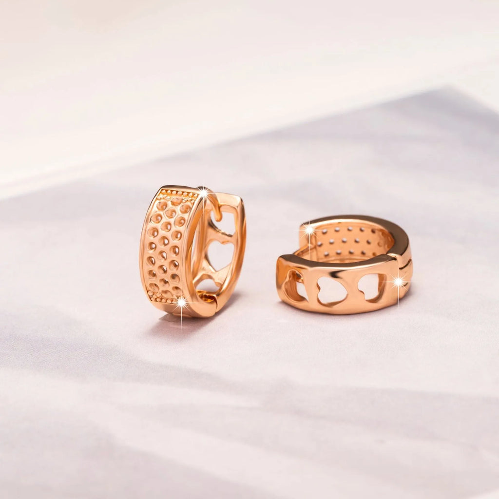 Rose gold electroplated earrings with hollow three-heart design in circular shape