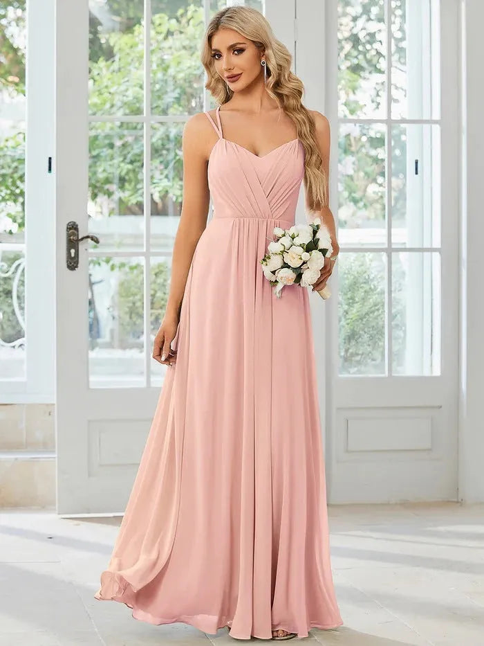 A sleeveless light green women's dress with a pleated A-line long skirt on a mannequin.