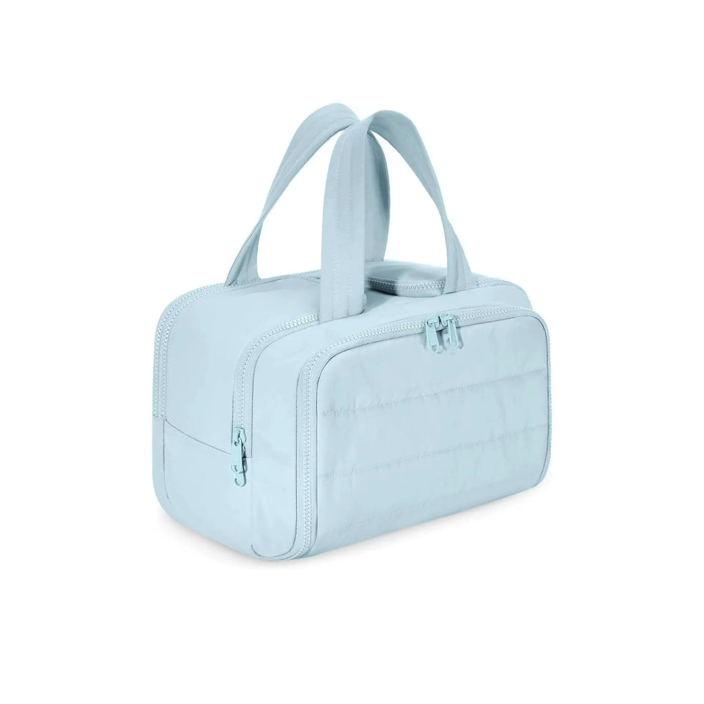 Large fluffy travel toiletry bag open wide showing soft interior, available in beige, black, light blue, pink, purple, and creamy-white.