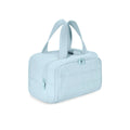 Large fluffy travel toiletry bag open wide showing soft interior, available in beige, black, light blue, pink, purple, and creamy-white.