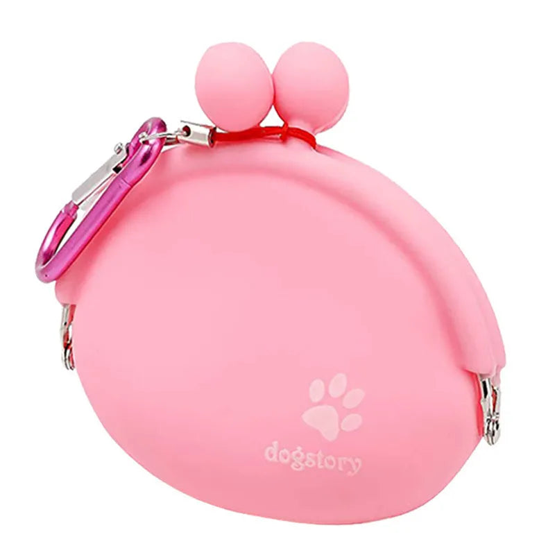 Yellow silicone dog treat pouch with hook-and-loop waist strap on a green background.