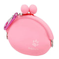 Yellow silicone dog treat pouch with hook-and-loop waist strap on a green background.