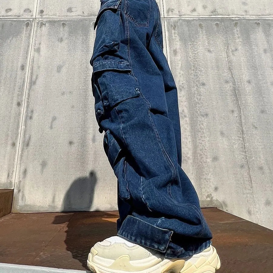 Dark blue distressed wide-leg jeans with high waist, multiple pockets, and raw hem detail