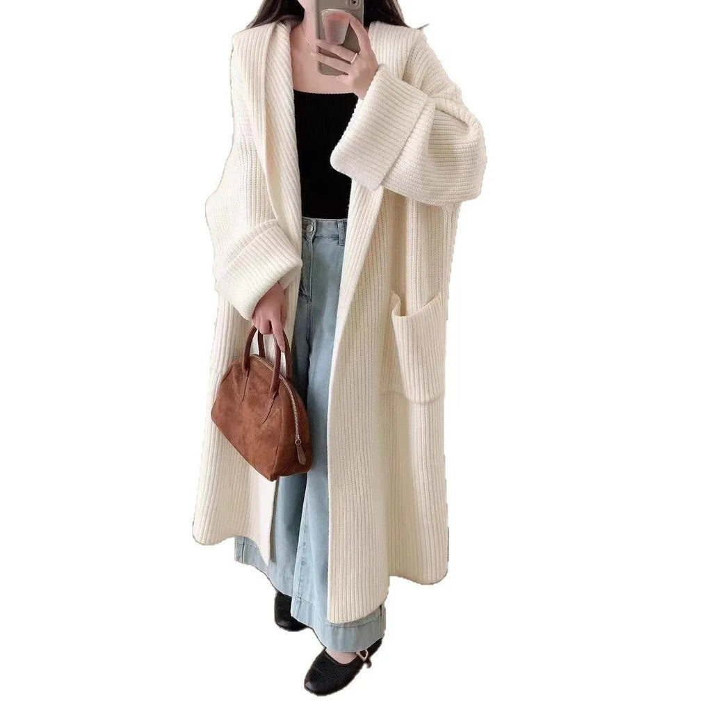 Women's loose grey hooded cardigan coat with raglan sleeves on hanger
