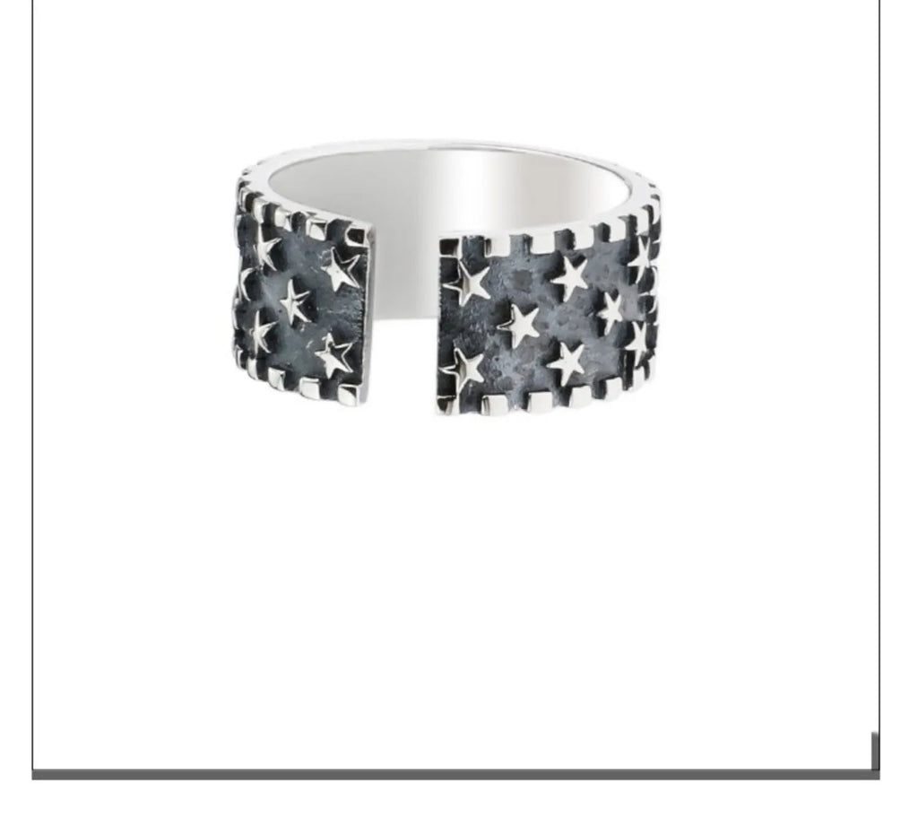 Adjustable open-ended sterling silver ring with a five-pointed star design.