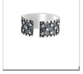 Adjustable open-ended sterling silver ring with a five-pointed star design.