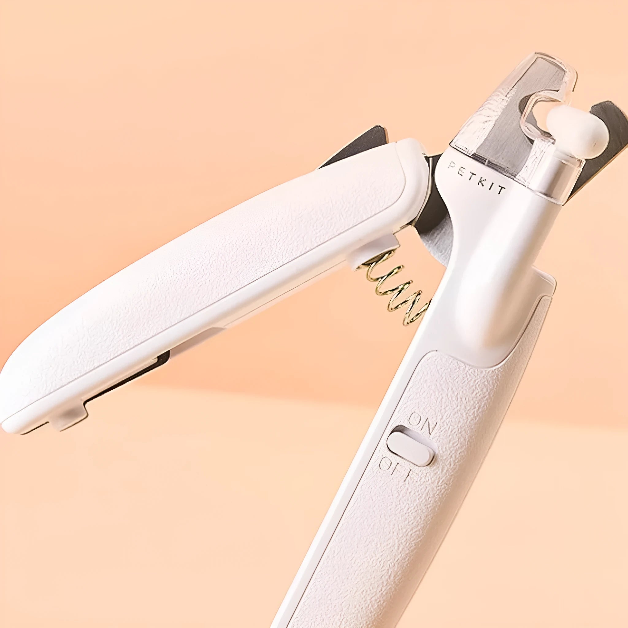 White LED pet nail clippers with transparent guard open, showing triangular steel blades and a nail file.