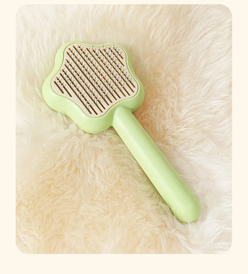 Green or yellow self-cleaning cat comb with stainless steel teeth, showing 20cm length.