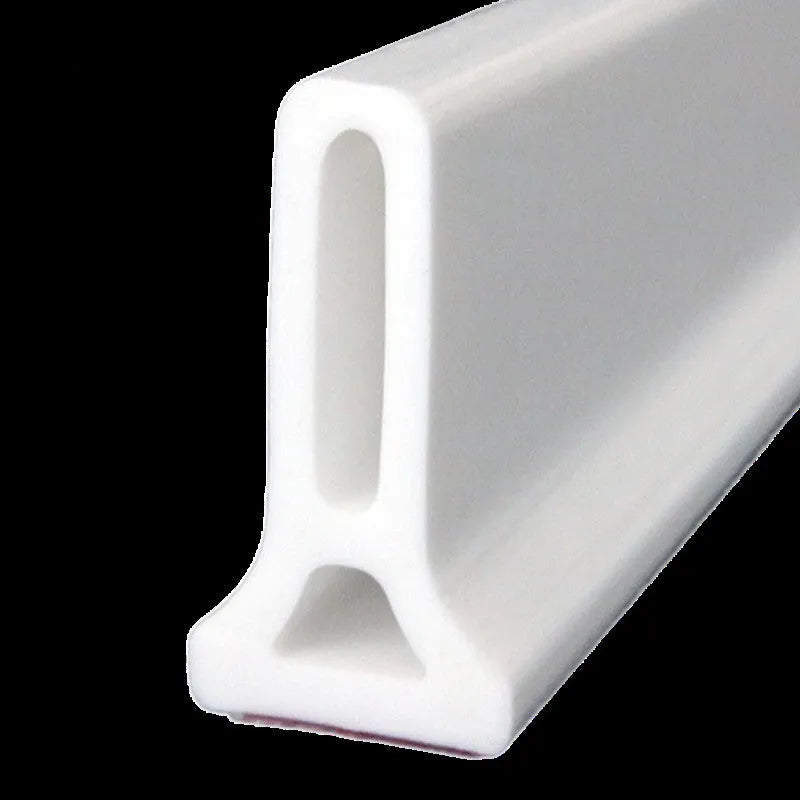 Flexible TPE bathroom water blocking strip in black on white tile floor