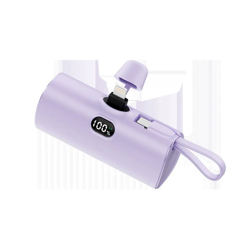 Compact capsule-shaped digital display power bank with integrated USB plug, shown in multiple colours.
