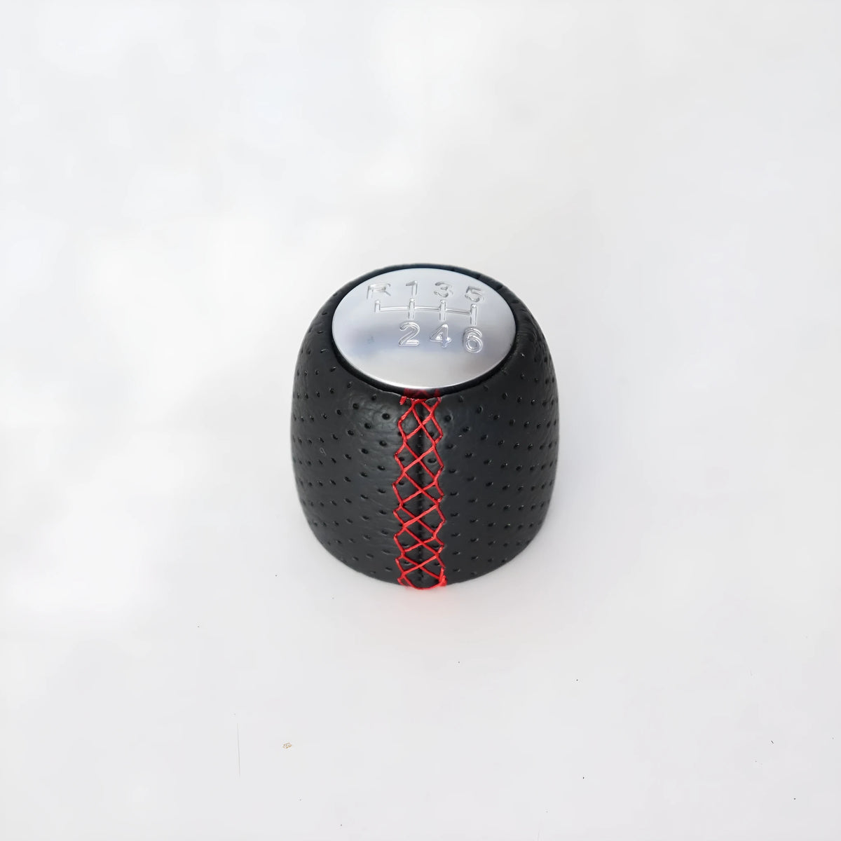 Black perforated PU leather gear knob for Alpha car with sewn seam, shown next to red and white line options.