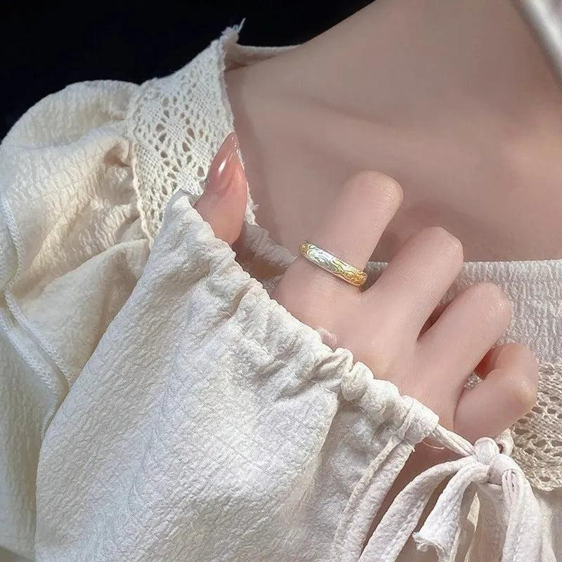 Open-mouth geometric ring with engraved xiangyun pattern in electroplated white copper showing silver and gold finish options