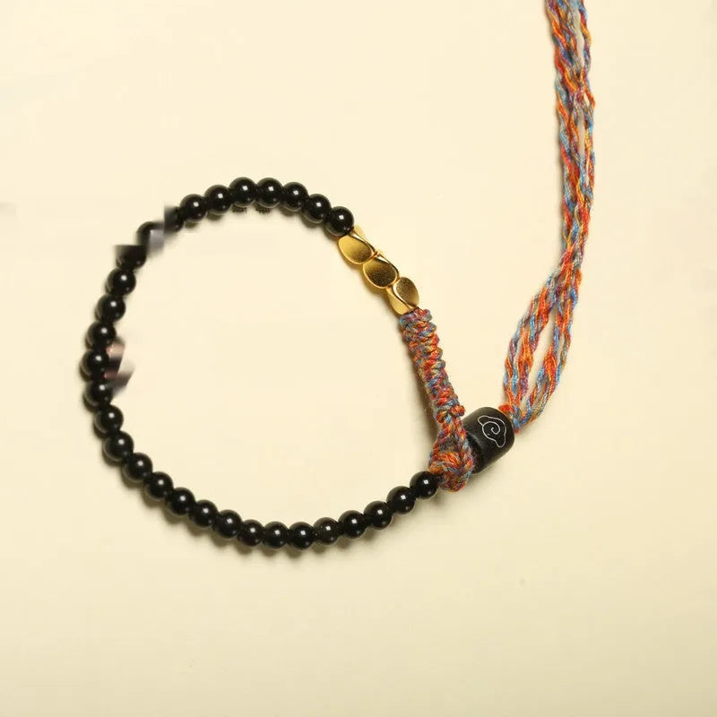 Hand-woven obsidian carrying strap bracelet showing 4mm width and woven texture detail