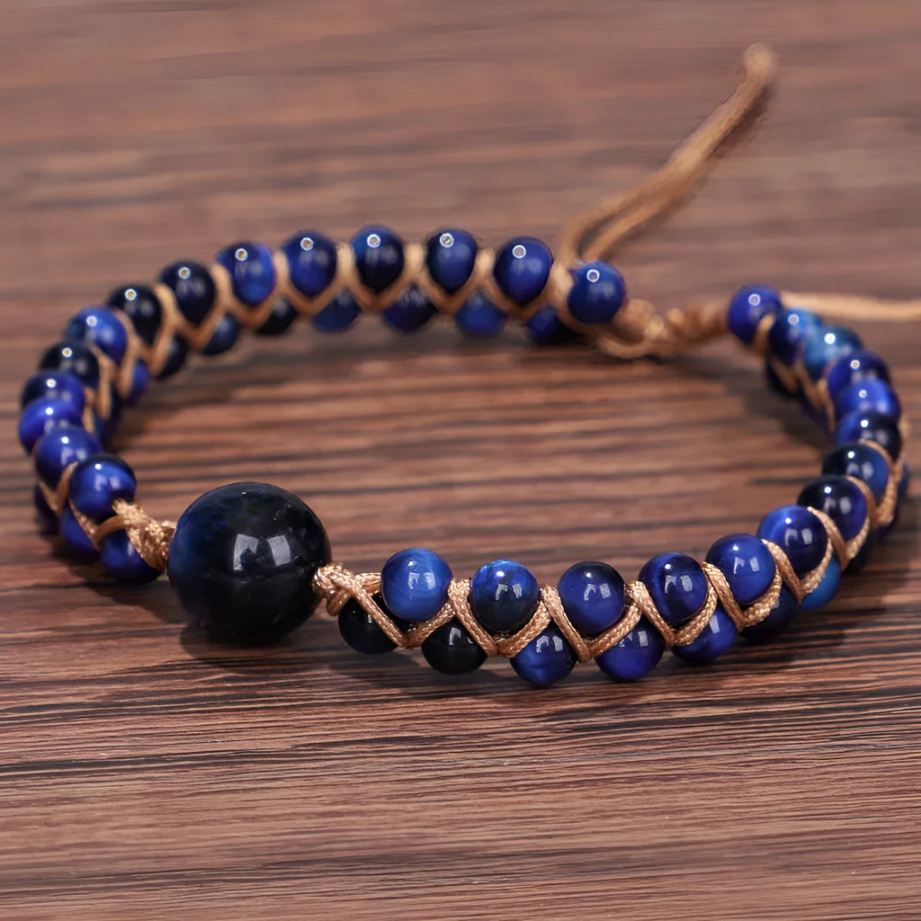 Handwoven geometric pull bracelet made from blue Tigereye stone beads with amethyst details
