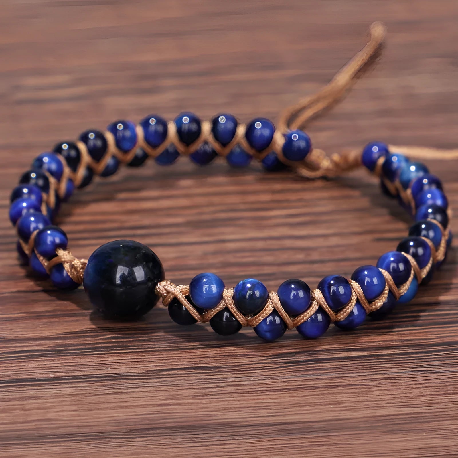 Handwoven geometric pull bracelet made from blue Tigereye stone beads with amethyst details