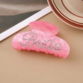 Pink acrylic hair clip with shark shape and diamond spot drilling, 10cm long with spring-clip back.