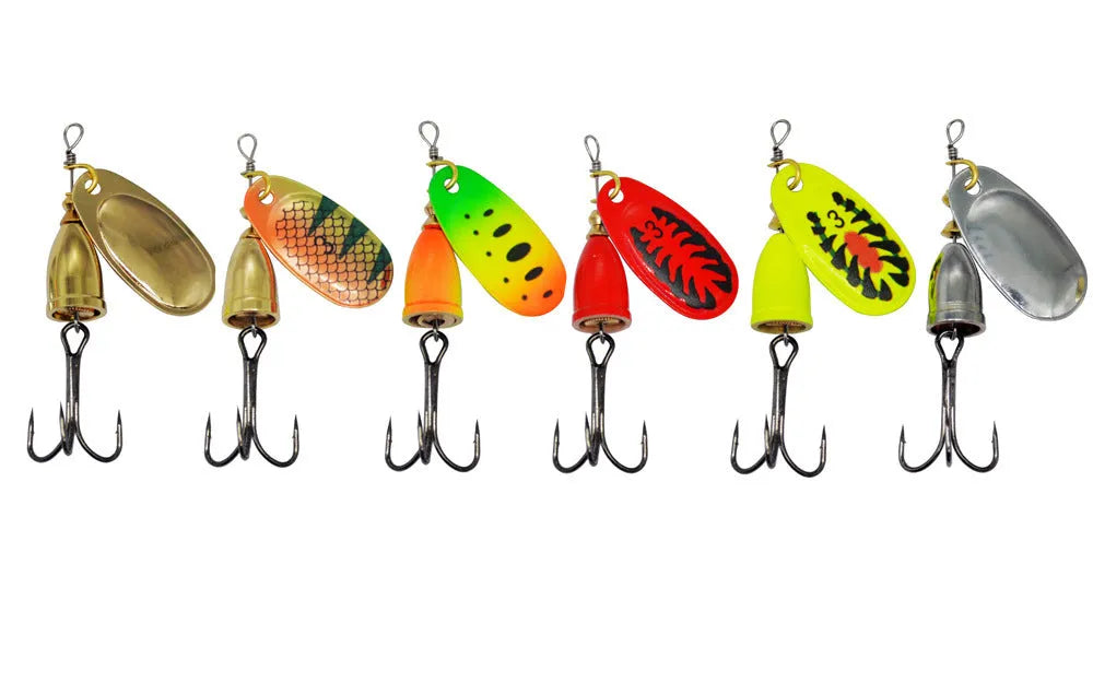 Rotating composite sequin copper bell metal fishing lure in seven colour variations on tackle background