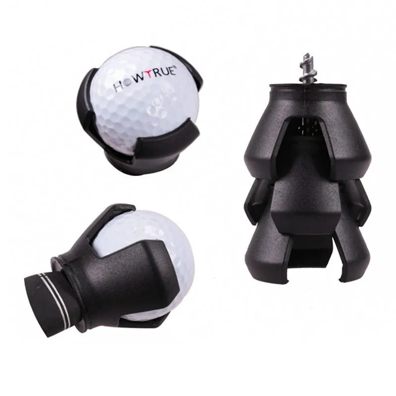 Black golf ball picker device with a clip, shown retrieving a ball on a green.