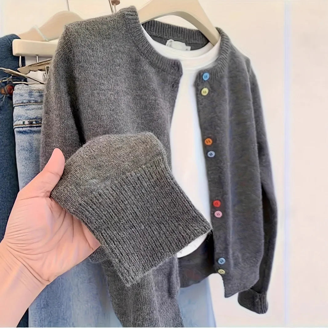 Dark grey women's button-front cardigan sweater on a hanger, showing long sleeves and regular length.