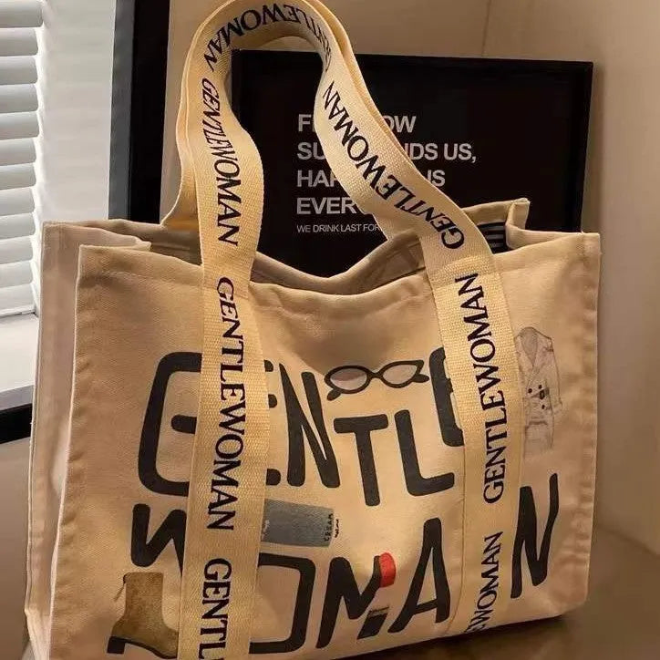 Large canvas tote bag with printed design, shown in available colour and pattern options.