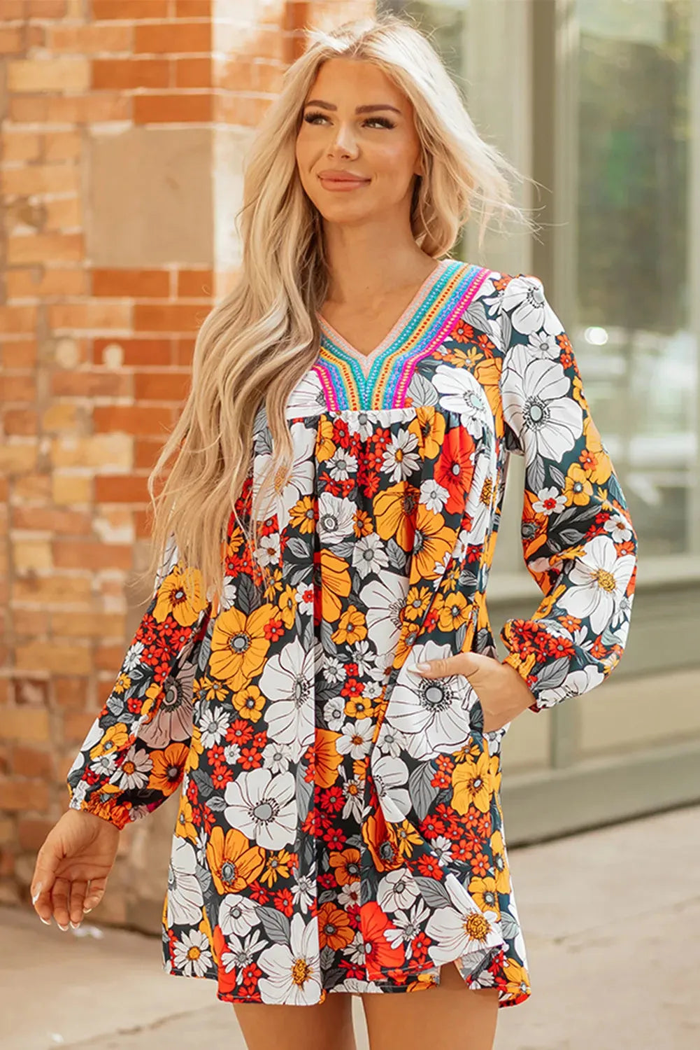 Orange floral print mini dress with V-neck, long sleeves, and striped lace trim
