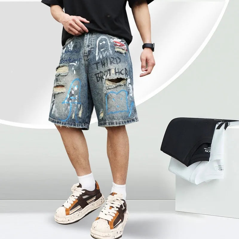 Blue ripped men's denim shorts with graffiti print and straight-leg cut.