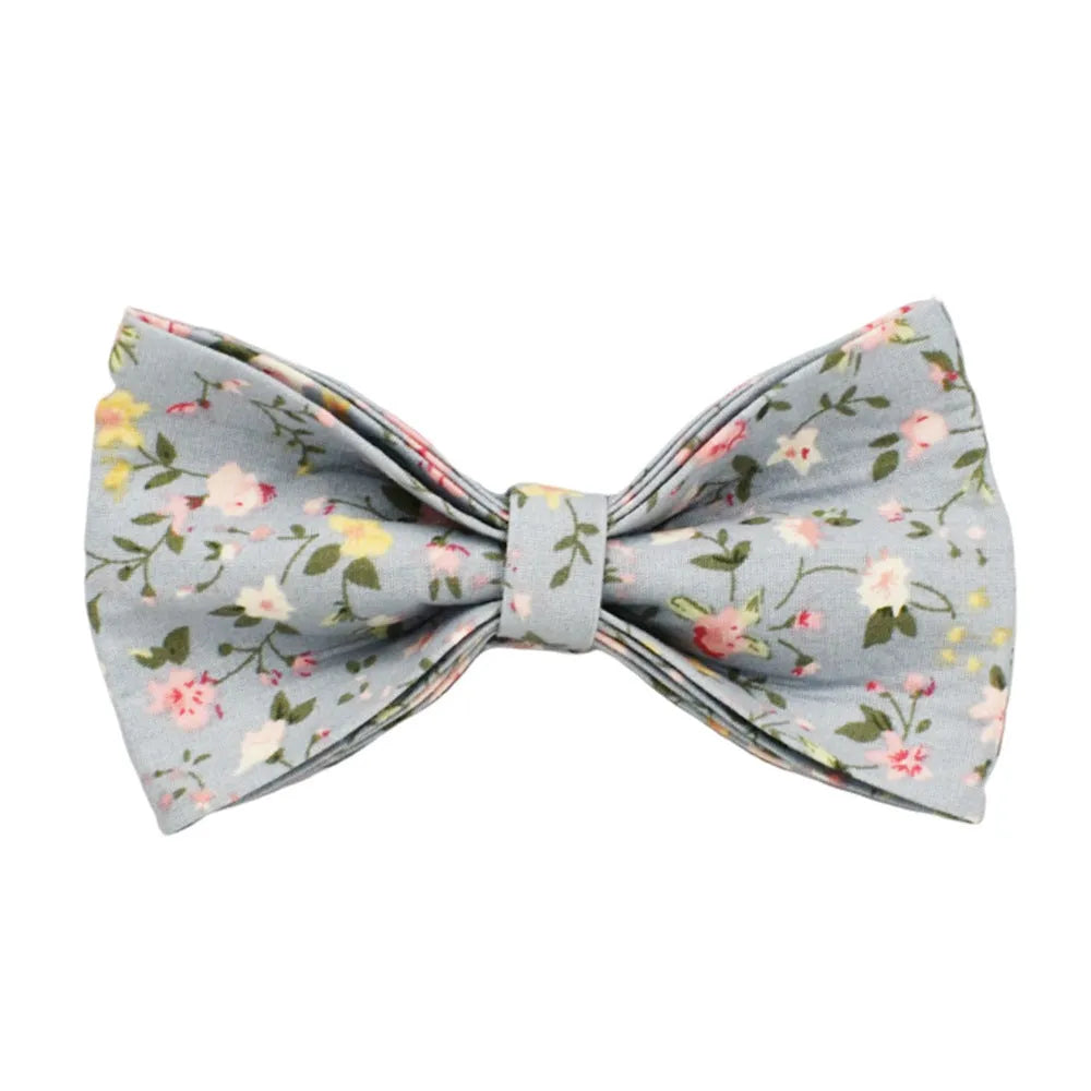 Blue floral pattern dog collar accessories set with adjustable collar, matching leash, bow, vest, and poop bag