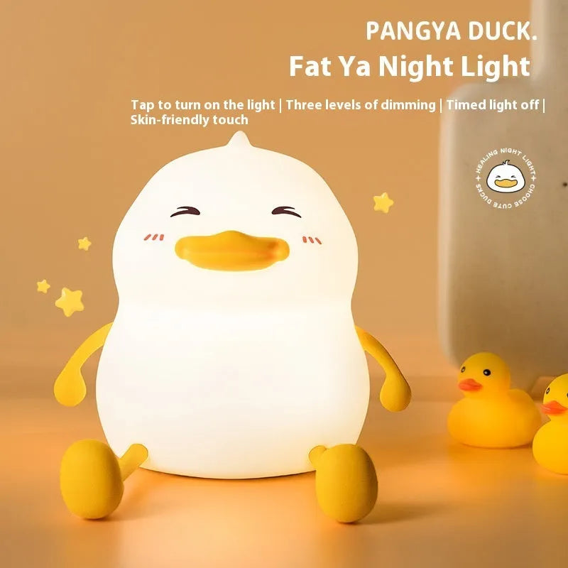 Chubby silicone rechargeable night light with phone holder on a desk