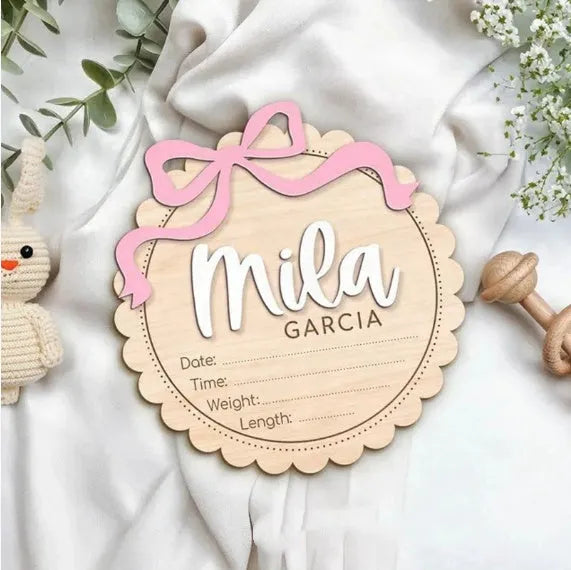 Customised square wooden baby ornament with a name for birthday or holiday decoration.
