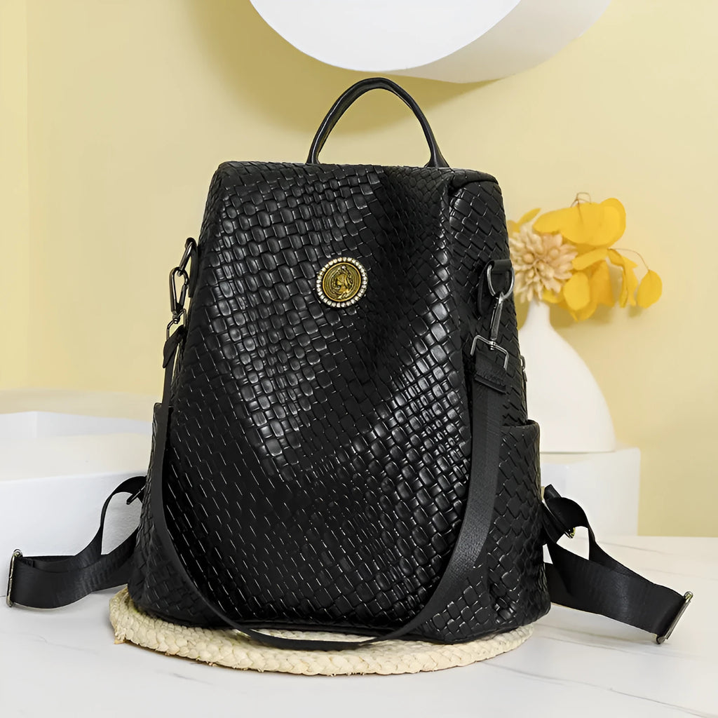 Women's black anti-theft backpack with waterproof PU construction showing organisational pockets and stitching details