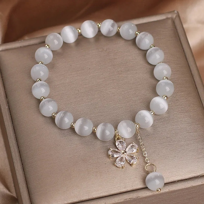 Women's white cat's eye crystal bracelet with flower tassels and safety buckle