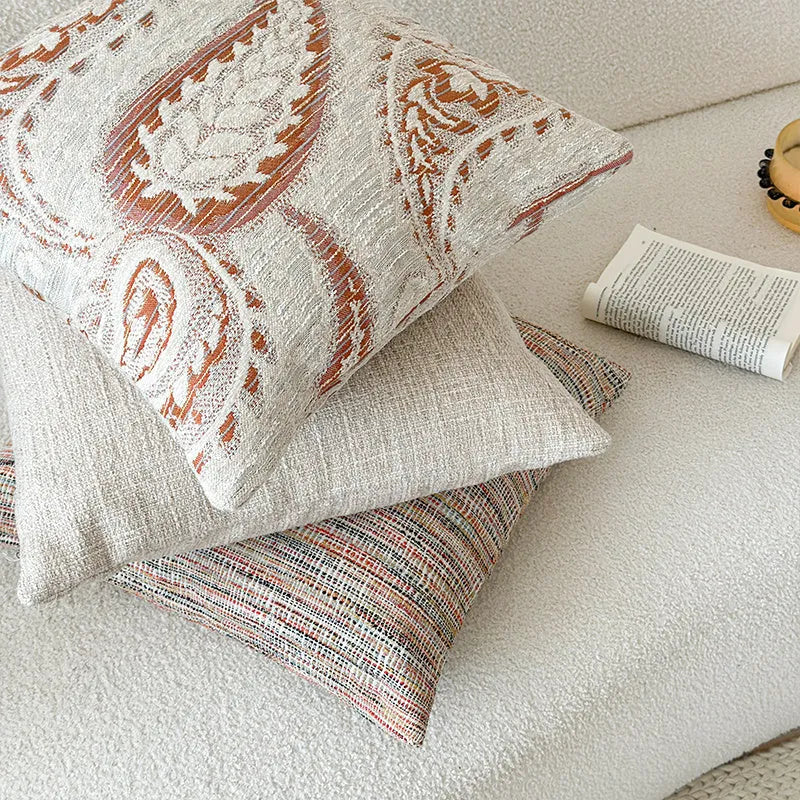 American-style jacquard paisley decorative pillow cover in amber tones on a sofa, showing square and rectangular size options.