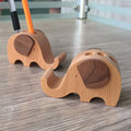 Beech wood mobile phone holder with resin animal decoration and custom lettering on coin back.