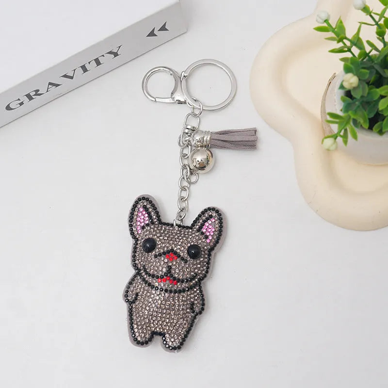 Close-up of a cartoon dog rhinestone keychain pendant on an alloy keyring