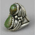 Geometric silver-toned women's ring with a central inlaid turquoise blue stone on a white background.